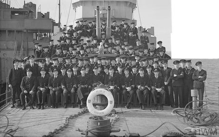 The crew of HMS Vivien at Sheerness in 1944. AB Jack Taylor is sitting between the guns of the forward turret. (c) IWM A 22070